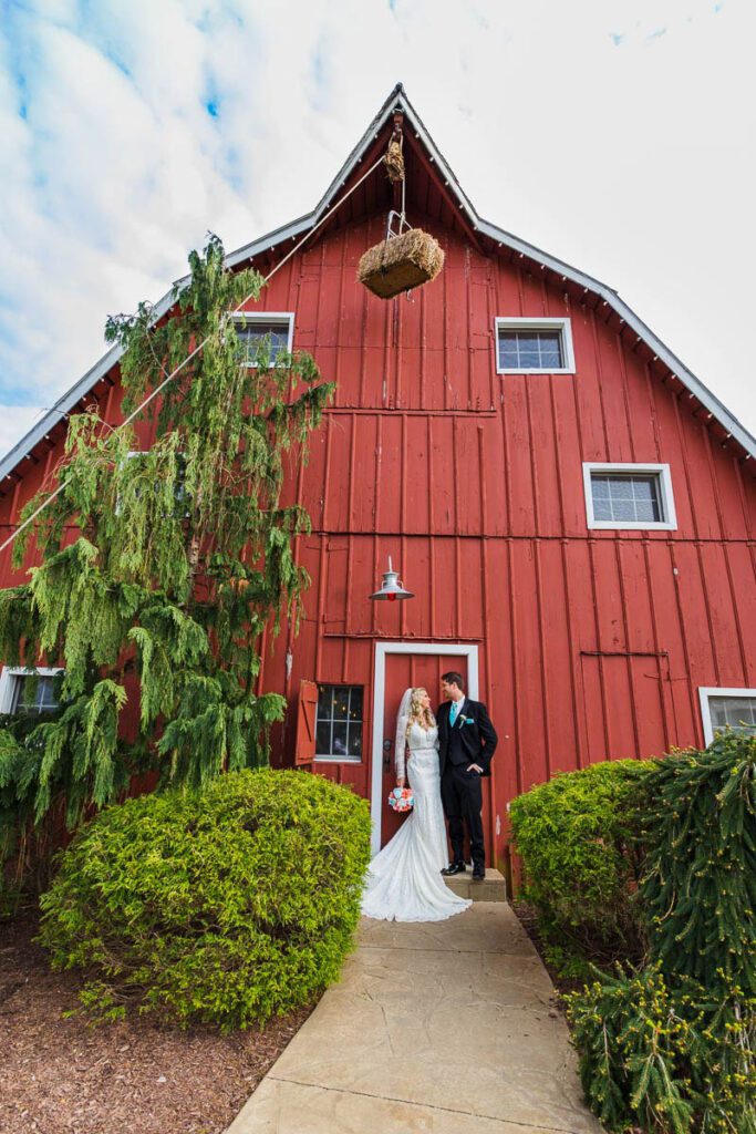 Jenna and Josh outside of a red barn building
