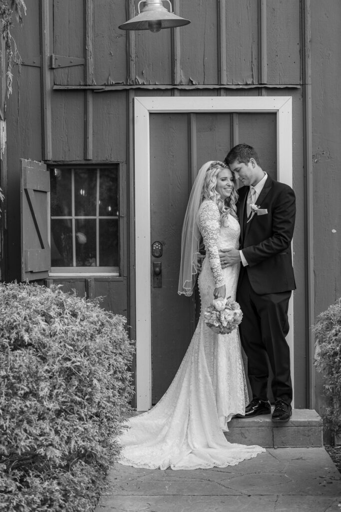 Jenna and Josh in front of a door in a grayscale image