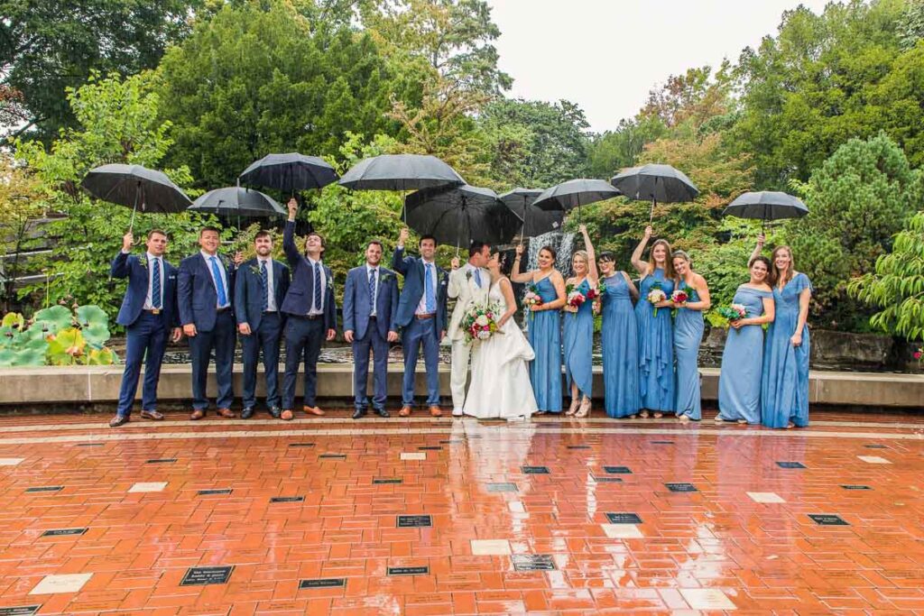 Ben and Claire with their attendants under the rain