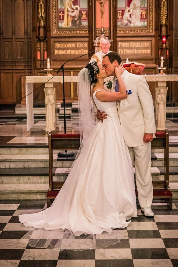 Claire and Ben kissing at the altar