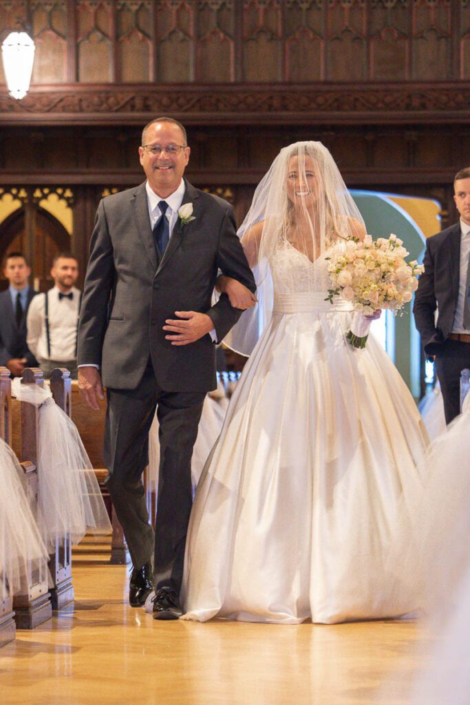 Mary walking on the aisle with her dad