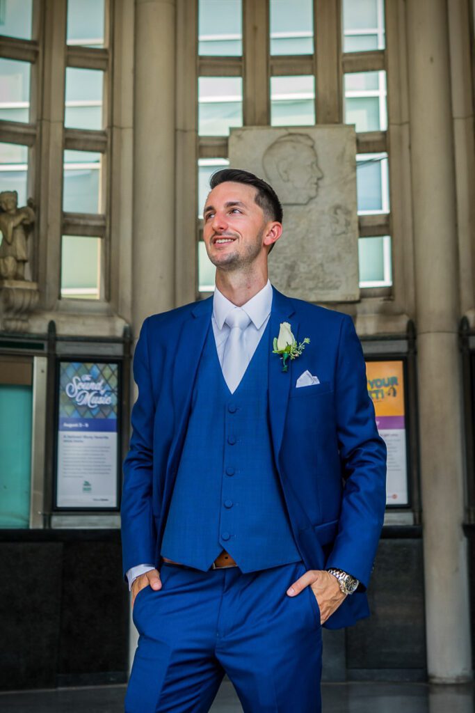 Matt smiling in his blue wedding suit