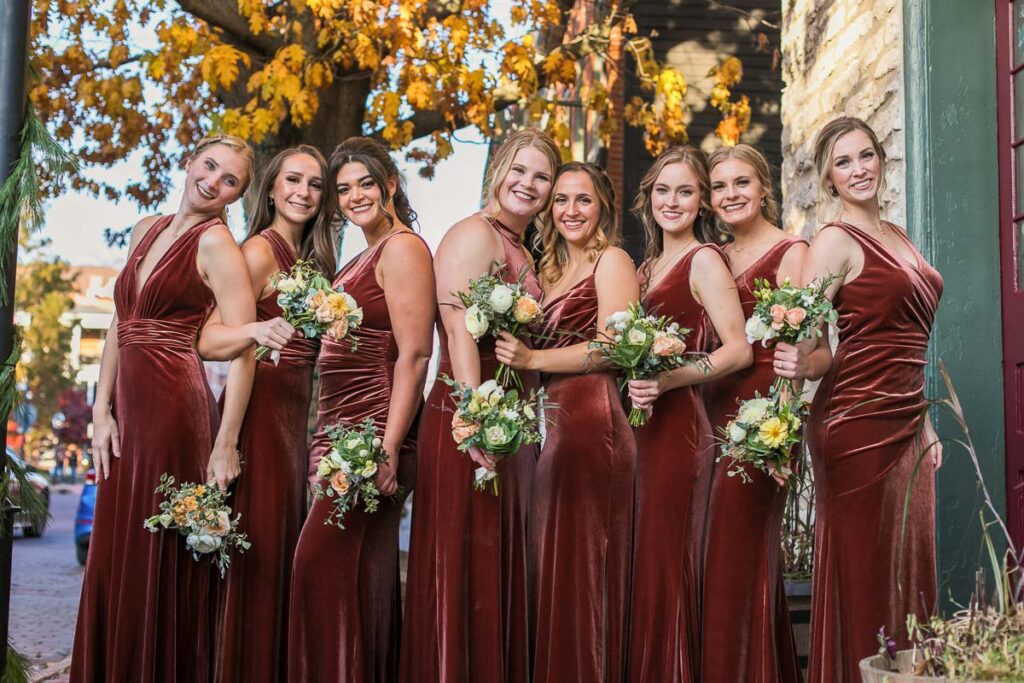 Julia’s bridesmaids in their brown red dresses