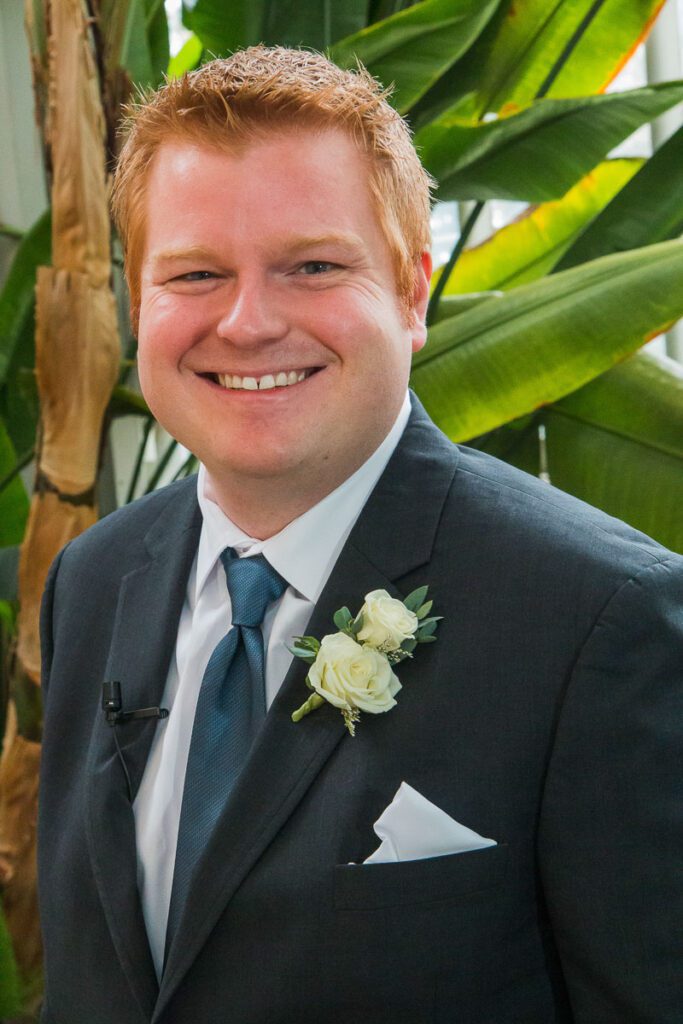 Brian smiling in his wedding suit