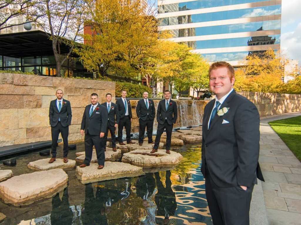 Brian and his groomsmen on a water feature