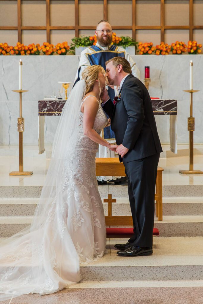 Anthony and Kim kiss at the altar