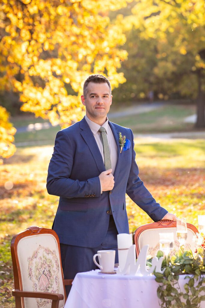 A groom holding a chair and his coat