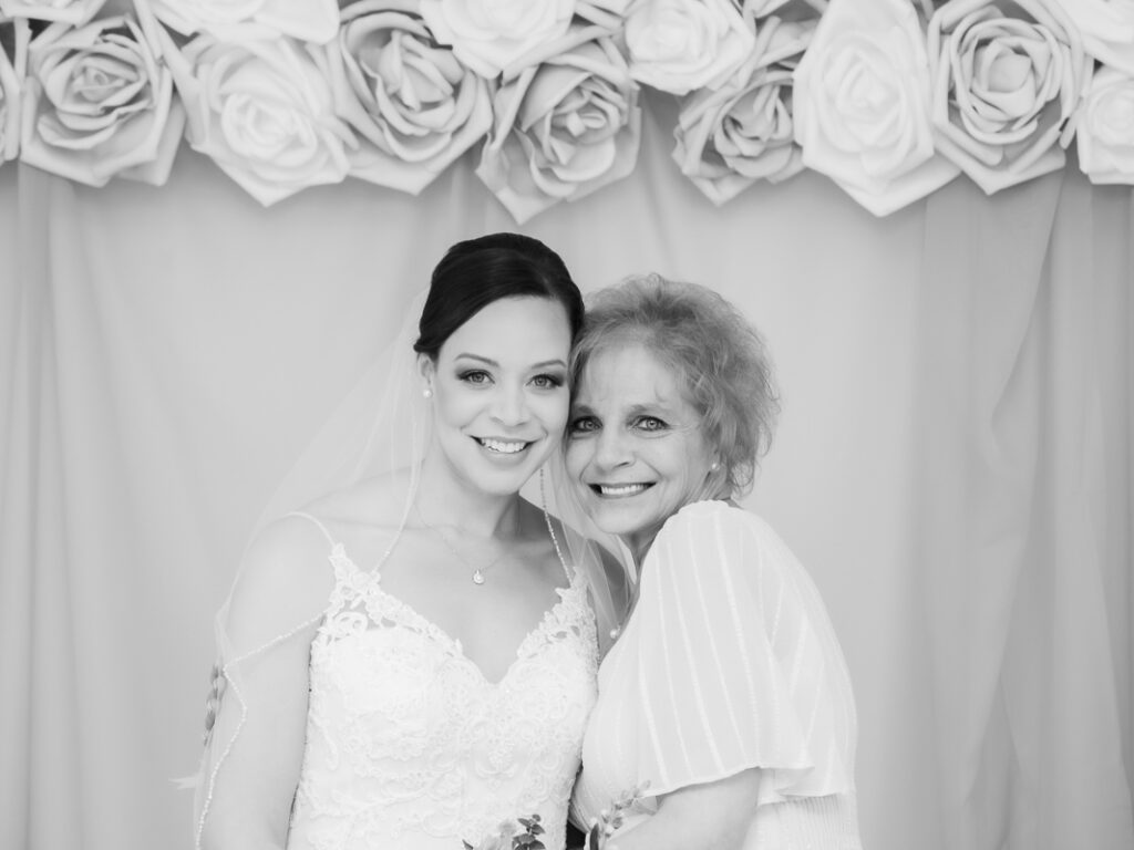 A black and white image of a bride with the old woman