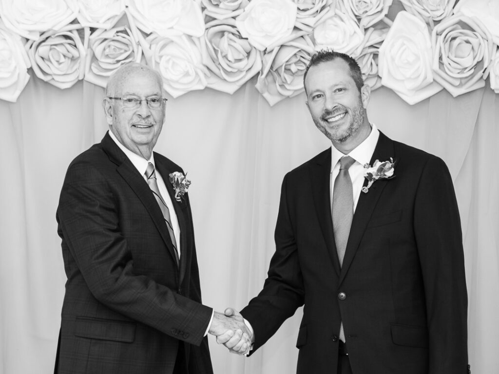 The groom shaking hands with his father
