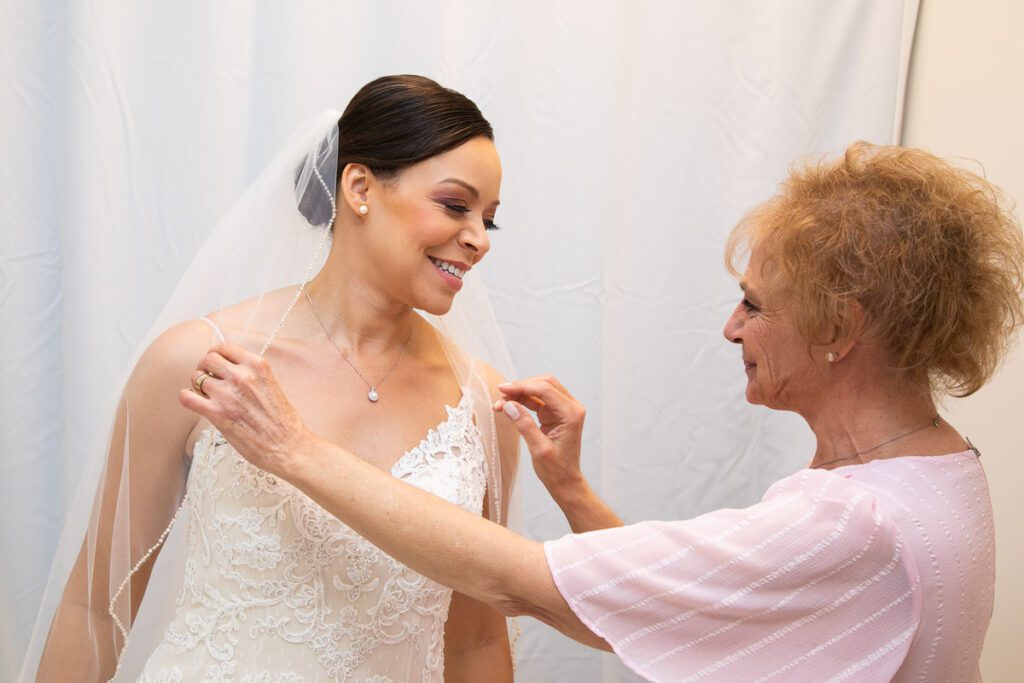 An old woman fixing the veil of the bride