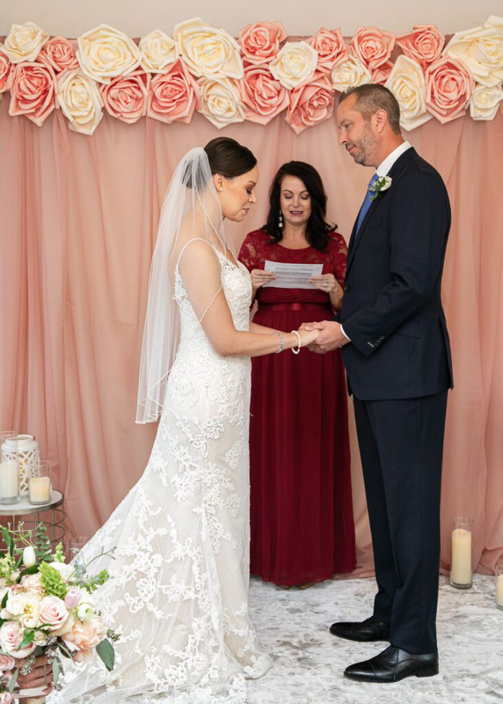 A bride and groom holding hands at the altar