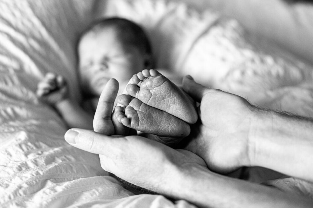 Hands holding a baby’s feet