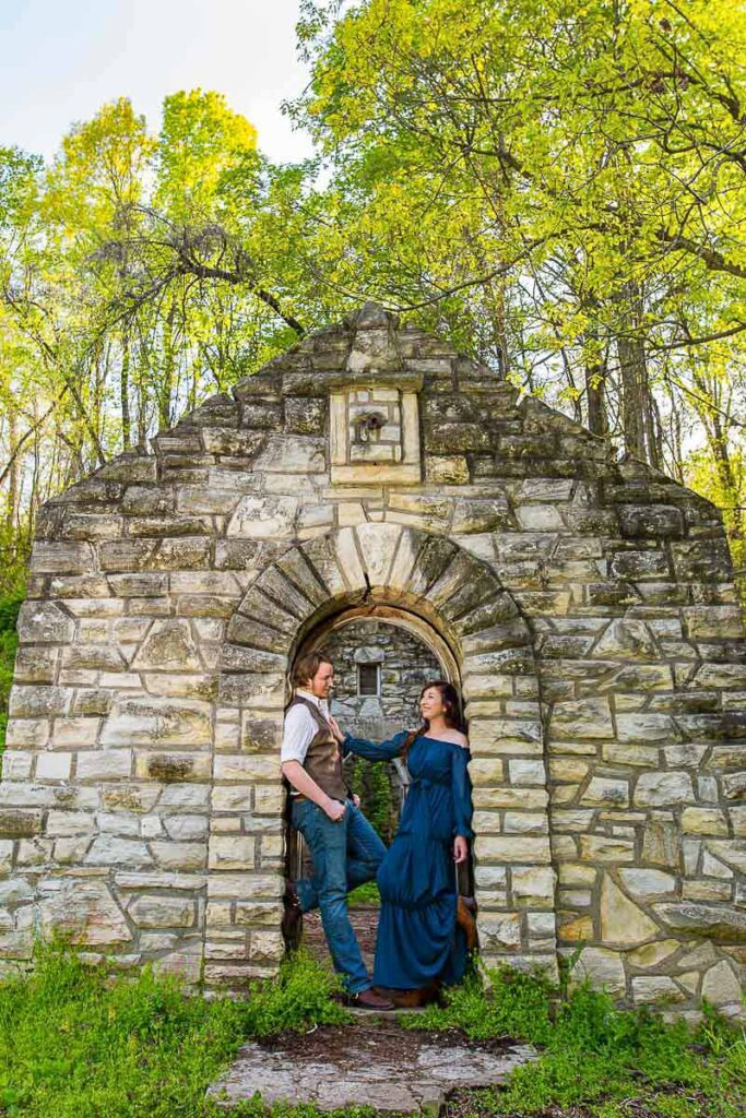 Erin and Will standing at the stone archway