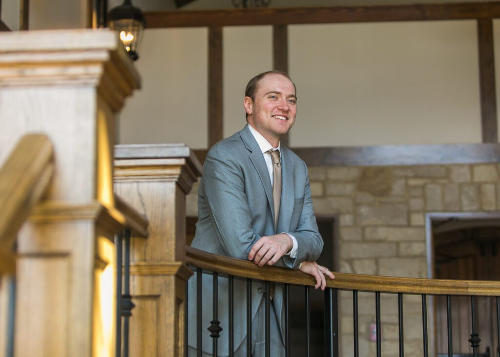 Groom Leaning on the staircase wall