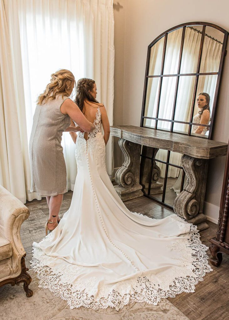 Bride is getting ready with her wedding gown