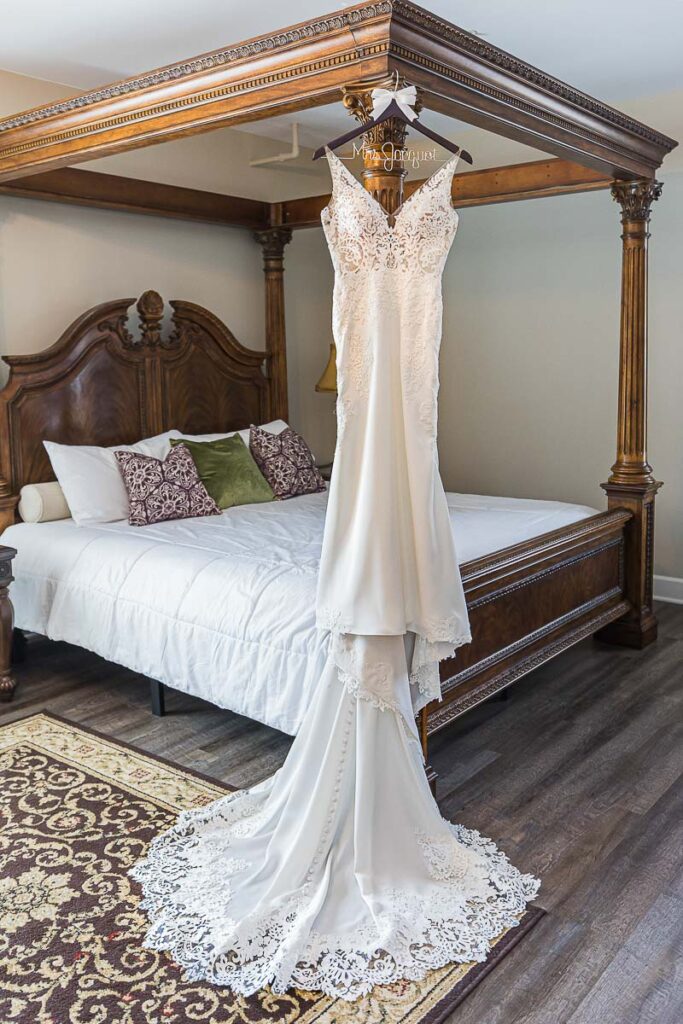 Wedding dress hanged on bed