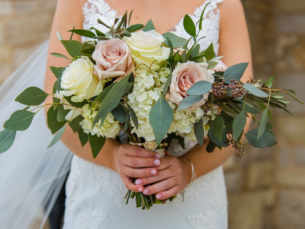 A close shot of bride holding bouquet