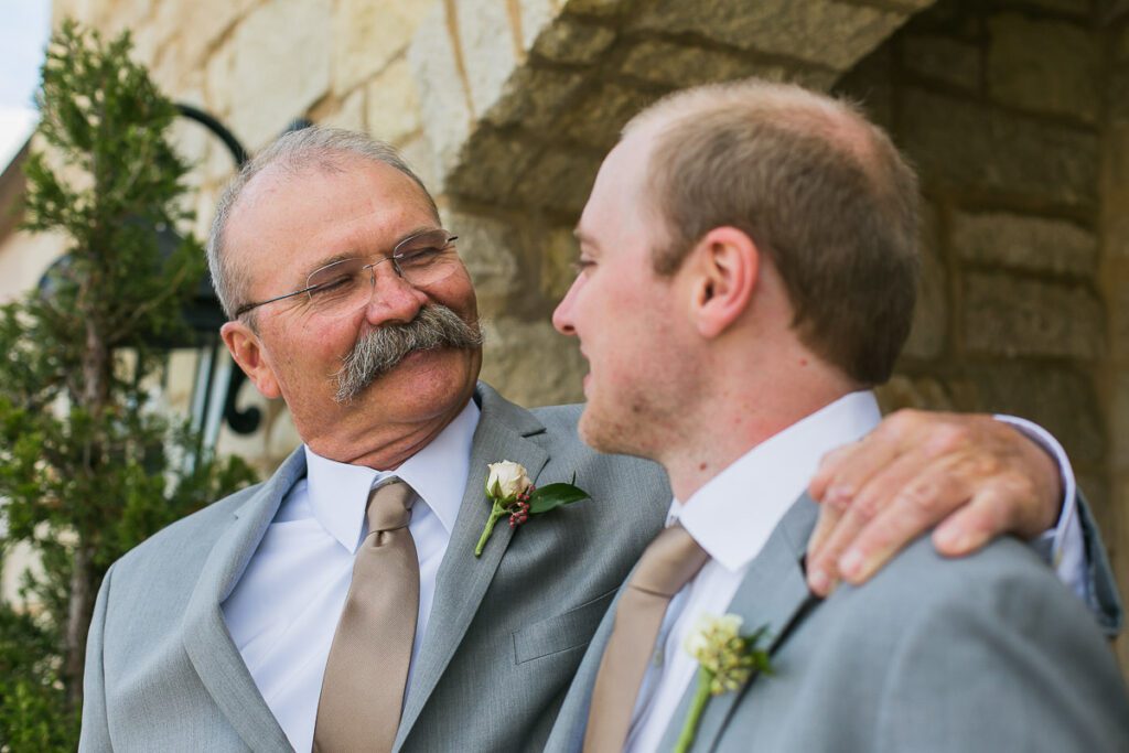 A man puts his hand on Groom's Shoulder