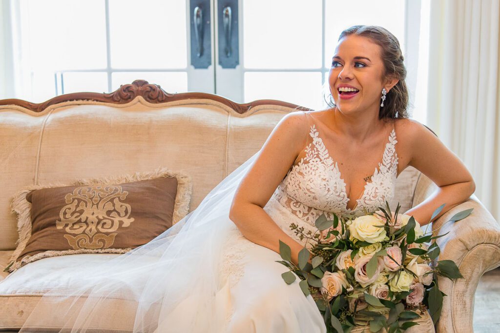 A close shot of bride smiling with bouquet