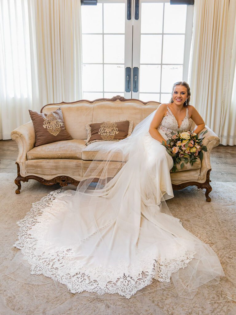 A close shot of bride with her wedding gown and bouquet