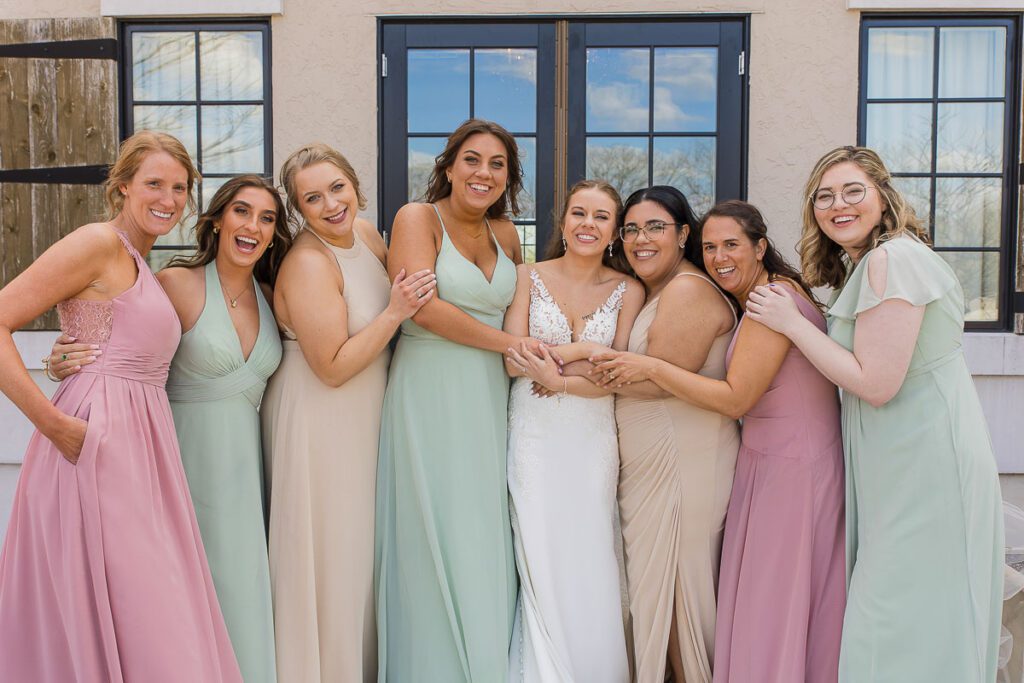 A close shot of Bride and Bridesmaid holding each others hand