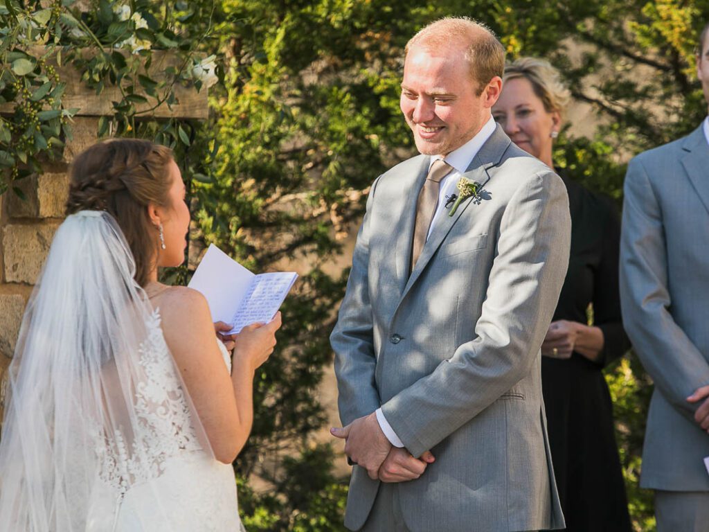 Groom is smiling at bride's note reading