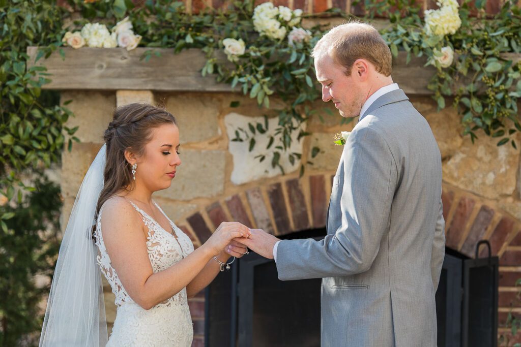 Bride exchanging ring with groom