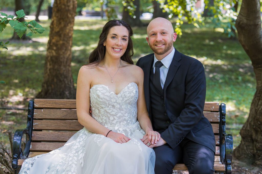 Bride and Groom sitting on a bench