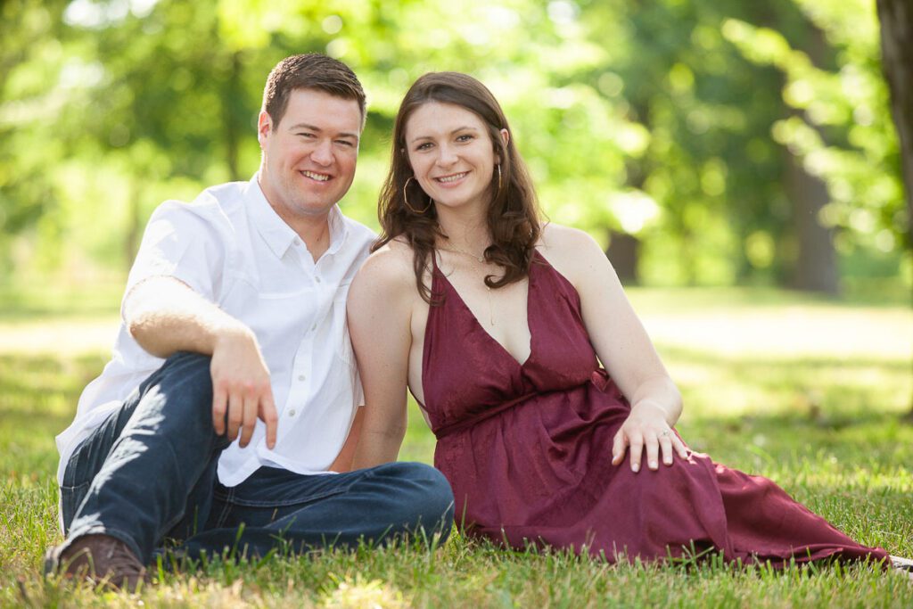 Couple sitting on grass and smiling