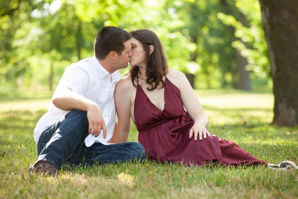 Couple sitting on grass and kissing